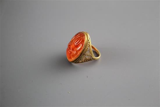 A 14k filigree yellow metal and orange chalcedony set dress ring, carved with fruit, size M, gross weight, 6 grams.